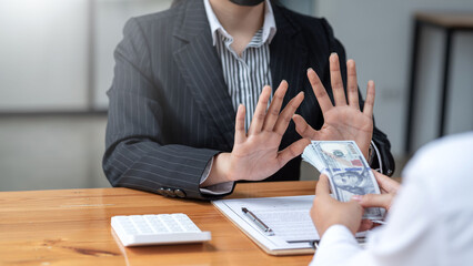 Lawyer refuses to accept bribe from business people in contracting. Corruption and anti bribery concept.