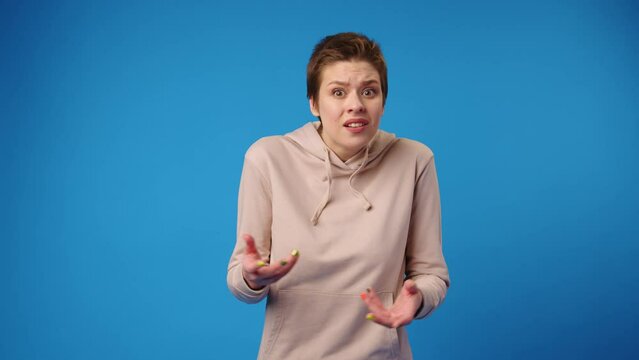 Puzzled young woman showing she doesn't understand