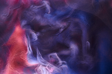 Blue pink smoke on black ink background, colorful fog, abstract swirling ocean sea, acrylic paint pigment underwater