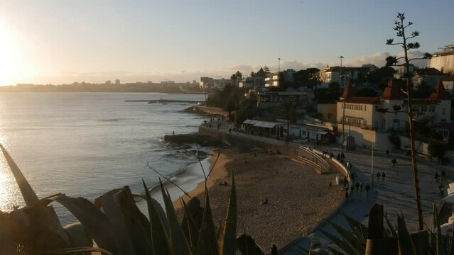 Cascais, Portugal - February 5, 2022: High perspective timelapse view of people at the promenade at Poca Beach