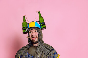 Half-length portrait of funny looking man, medieval warrior or knight in beer helmet and protective...