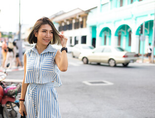 Fototapeta premium Happy beautiful Asian woman enjoys travel Vacation summer holidays in city. Asian female traveler.