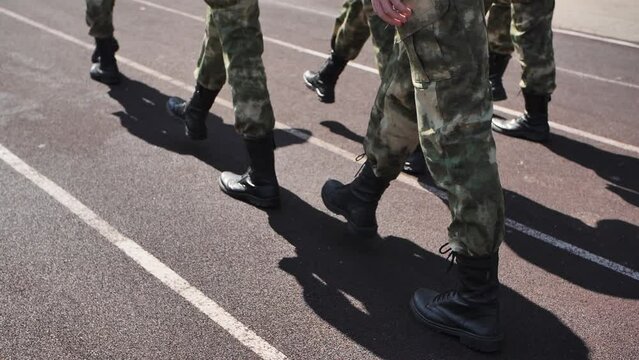 Soldiers marching in a row. Young soldiers marching in slow motion