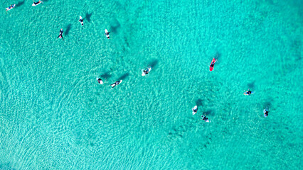 Fototapeta premium People surfing on clear sea