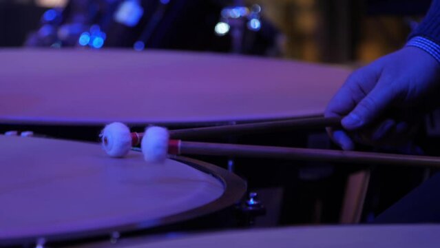 Close-up of a drummer playing timpani at the orchestra concert. Drummer playing timpani at the orchestra concert