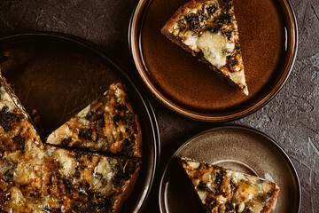 Homemade vegetable pie on dark background. Rustic food photography. Low key image. Top view with copy space.