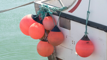 Orange buoys. Boat fenders. Group. 
