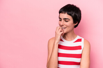 Young caucasian woman isolated on pink background relaxed thinking about something looking at a copy space.