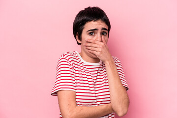 Young caucasian woman isolated on pink background scared and afraid.