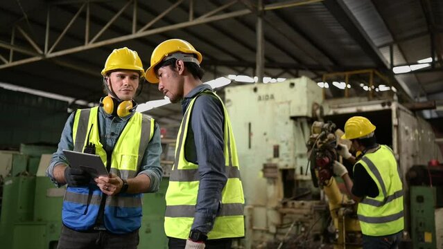 The foreign chief engineers teach and advise Asian technicians. About repairing old machinery to return to normal use