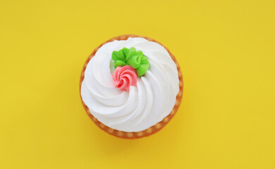 Cake with white air cream on a yellow background