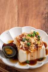 Delicious Chilled tofu and century egg with soy sauce and bonito flakes.