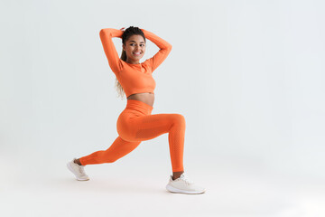 Black young sportswoman doing exercise while working out
