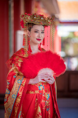 Portrait young beautiful Asian woman wear red cheongsam red.