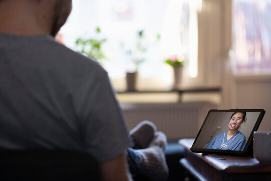 Man having online doctor consultation on digital tablet