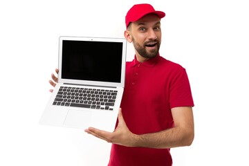 Delivery service courier demonstrates laptop screen with special offer in red uniform on white...