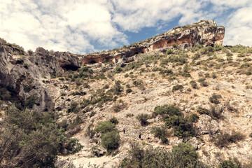 Group of hikers in the Route of Six Thousand Steps, at Barranc de l’Infern. The Hell’s Ravine in Vall de Laguar, Alicante, Spain