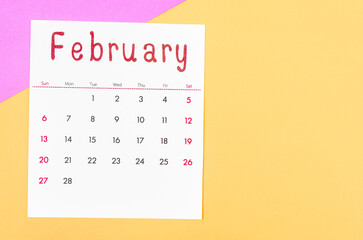 February 2022 calendar on multicolored background.