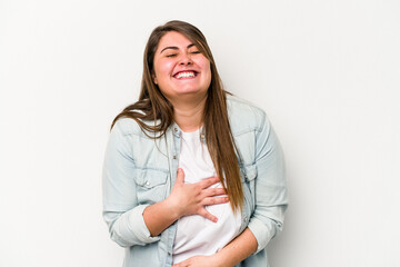Young caucasian overweight woman isolated on white background laughs out loudly keeping hand on...