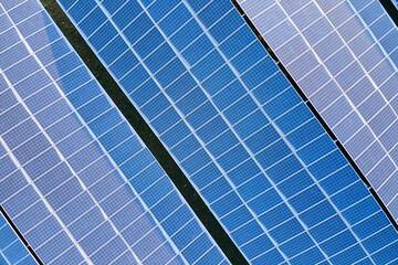 Aerial view building roof with rows of blue solar photovoltaic panels for producing clean ecological electric energy. Renewable electricity with zero emission concept