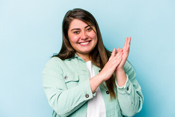 Young caucasian overweight woman isolated on blue background feeling energetic and comfortable,...