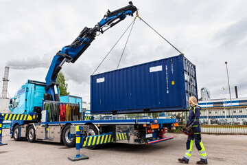 Woman assisting with carrying cargo container