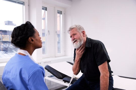 Senior man with throat pain having doctor appointment