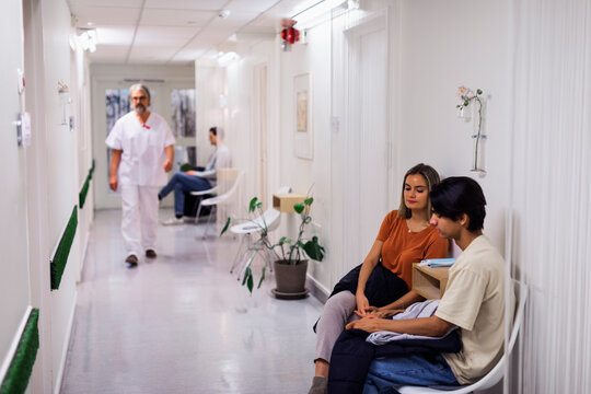 Doctor and patients in hospital corridor