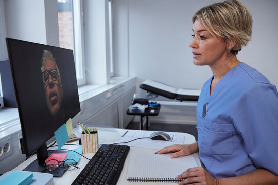 Female doctor having online consultation with senior patient
