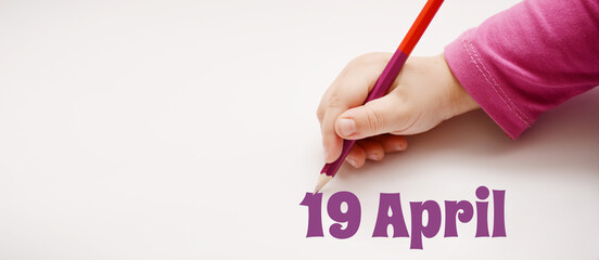 A child's hand writes 19 april in a lilac pencil. Banner with copy space