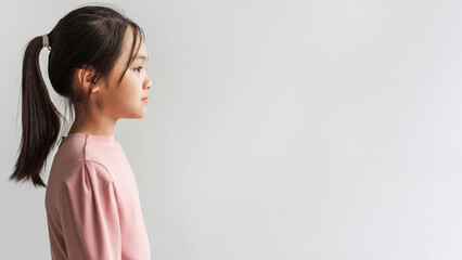 Profile Portrait Of Serious Asian Girl Looking Aside, Gray Background