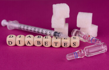
Sugar cubes and insulin syringe and ampoules with insulin. Raised diabetes concept