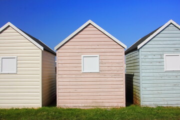 Fototapeta na wymiar Beach huts against summer blue sky
