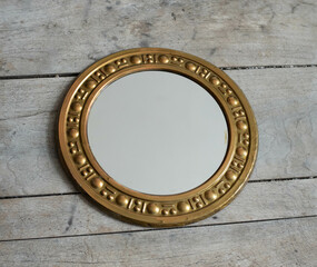 Mid-century modern copper framed mirror on a wooden boards