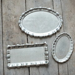Vintage silver trays on a wooden board