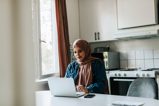 Woman using laptop at home