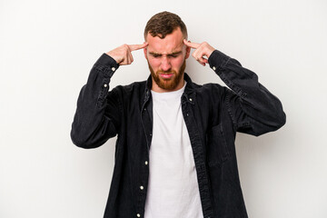 Young caucasian man isolated on white background focused on a task, keeping forefingers pointing head.
