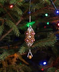 Vintage christmas tree ornament on the pine tree with light garland