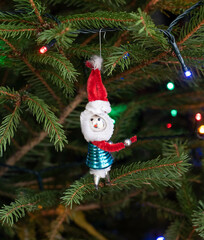 Vintage christmas tree ornament on the pine tree with light garland