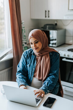 Woman using laptop at home