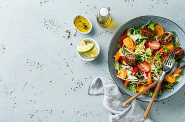 Foto op Aluminium Fresh colorful spring vegetable salad in the blue bowl - healthy organic vegan lunch. © pinkyone