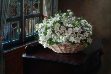 Still life with basket of white flowers