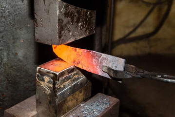A Blacksmith making knives in the old traditional smithy factory