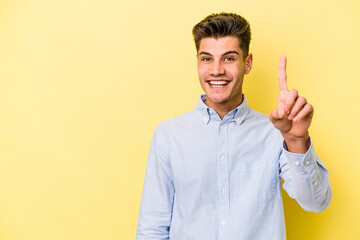 Young caucasian man isolated on yellow background showing number one with finger.