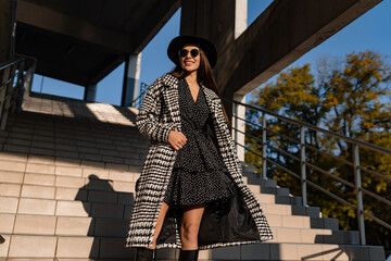 attractive young woman walking in autumn wearing coat