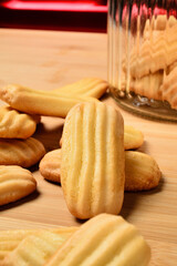Homemade biscuits and a jar on a pastry board. 