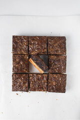 Cross section of brownies that have been cut into squares, Flat lay of brownies, caramel brownies on white parchment paper