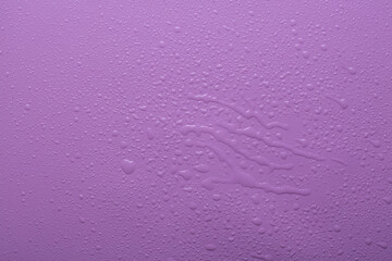 Water drops on purple  color  surface