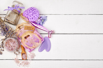 Lavender cosmetics - natural lavender soap bars with sea salt and lavender flowers. Aromatherapy, spa, wellness background. Top view on white table. natural aromatherapy body care cosmetics