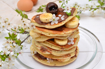pancakes with chocolate and banana decorated cherry blossom close up